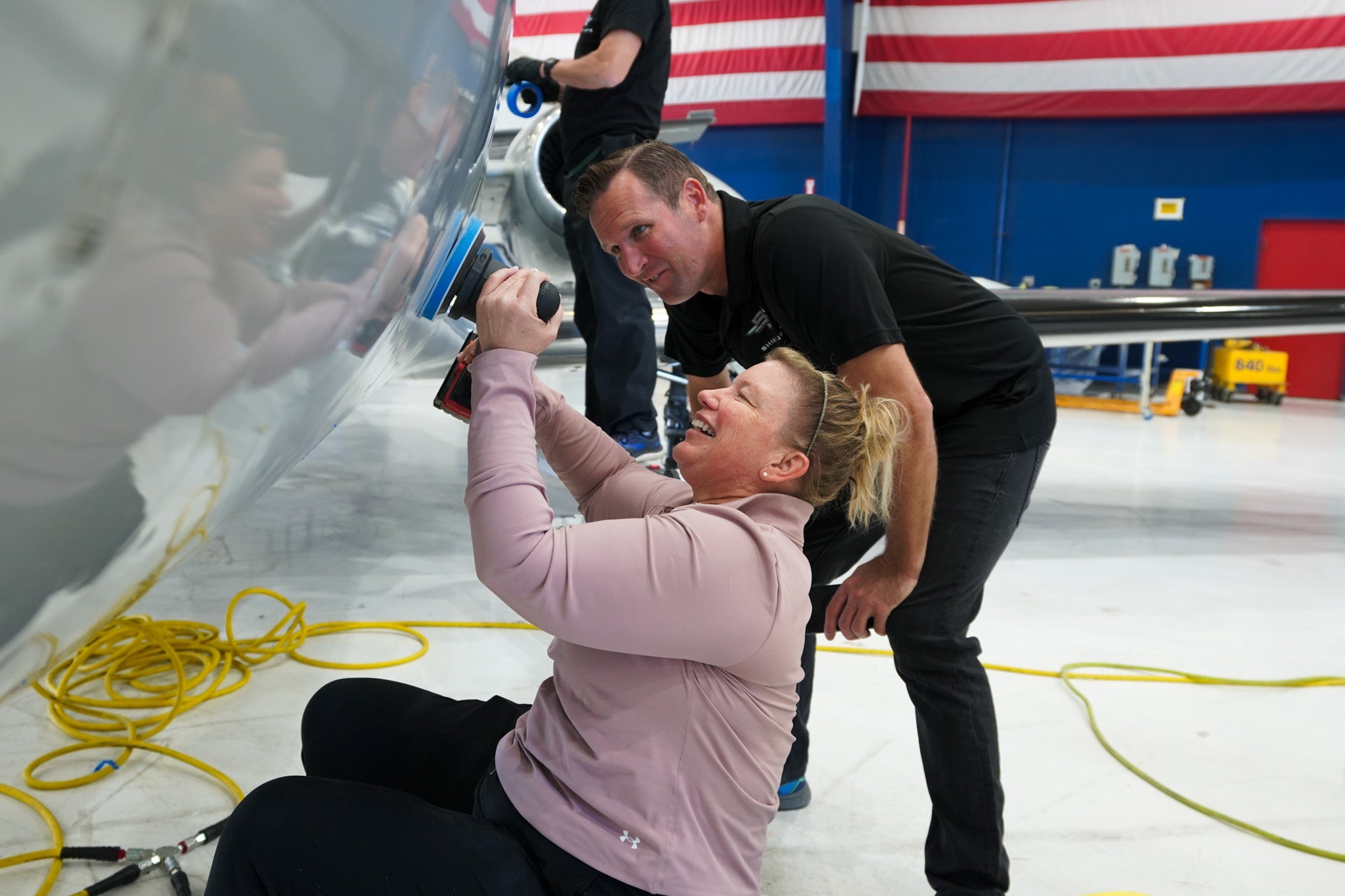 Brett Berry instructing a student in hands-on aircraft detailing training at Chino Airport